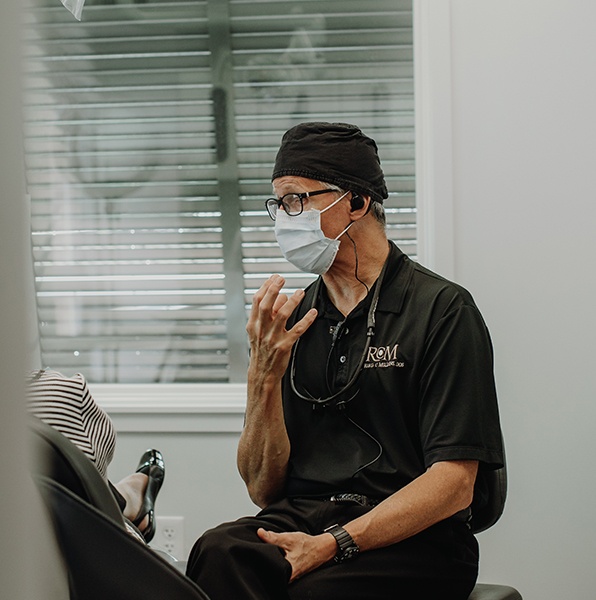 Dentist talking to dental patient in exam room