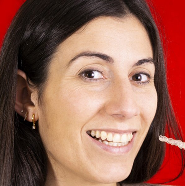 closeup of a patient holding her clear aligner in Jacksonville, FL