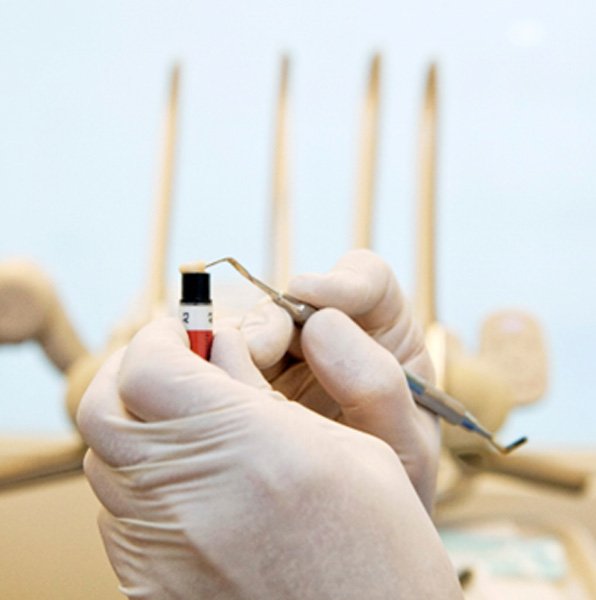 A dentist working with tooth-colored resin