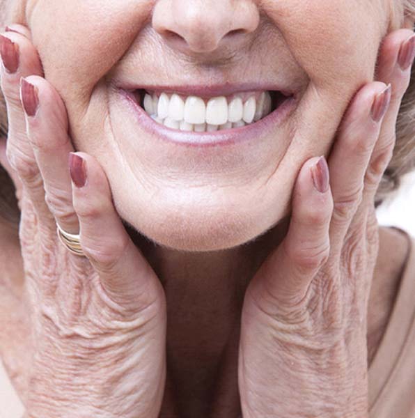 Closeup of woman smiling with dentures in Jacksonville