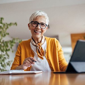 a woman smiling and working professionally