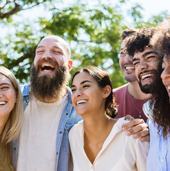 group of smiling people outside 