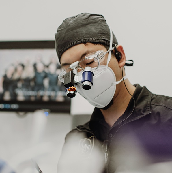 Dentist performing tooth extraction