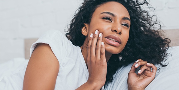Woman with toothache holding cheek