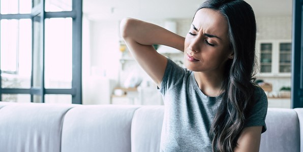 Woman in pain holding neck