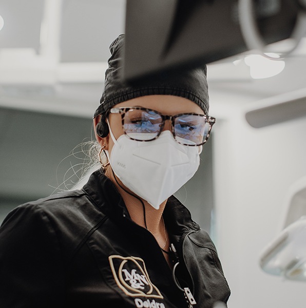 Dental team member providing root canal therapy