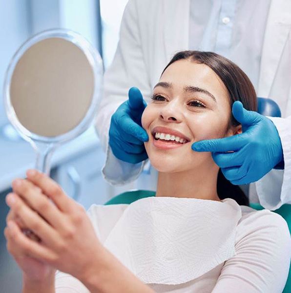 A woman admiring the results of her dental filling treatment