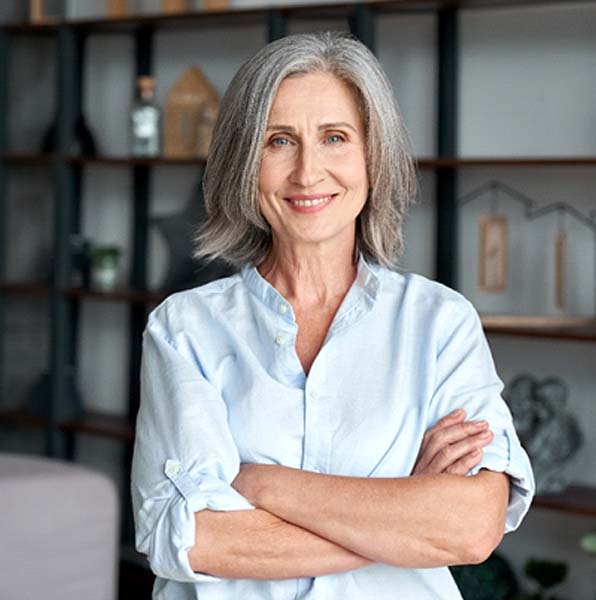 Woman smiling with her arms crossed inside