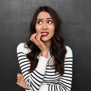 woman nervously biting her fingernails 