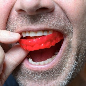 man wearing a red mouthguard 