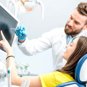 Implant dentist in Jacksonville showing a patient an X-ray