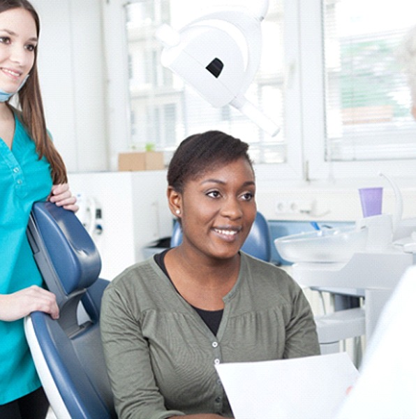 Patient and dentist discussing implant dentures in Jacksonville