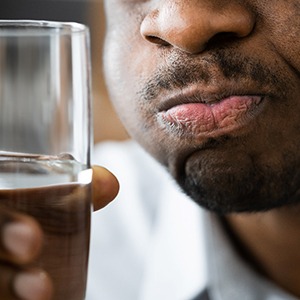 a man swishing with salt water