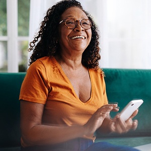 a woman on her phone on a couch