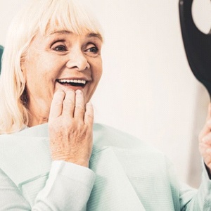 Woman admiring her new dental implants in Jacksonville