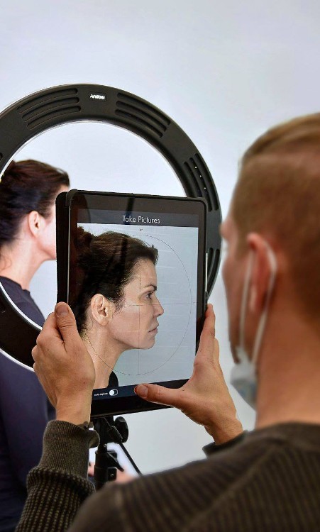 Dental team member taking photo of patient