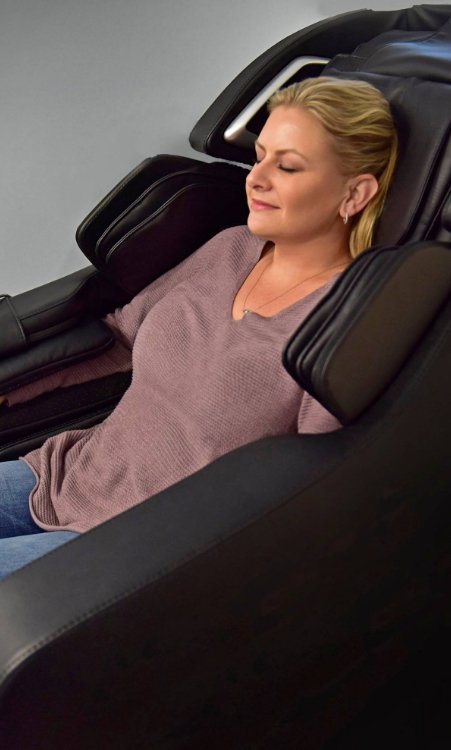 Woman relaxing in dental chair with eyes closed