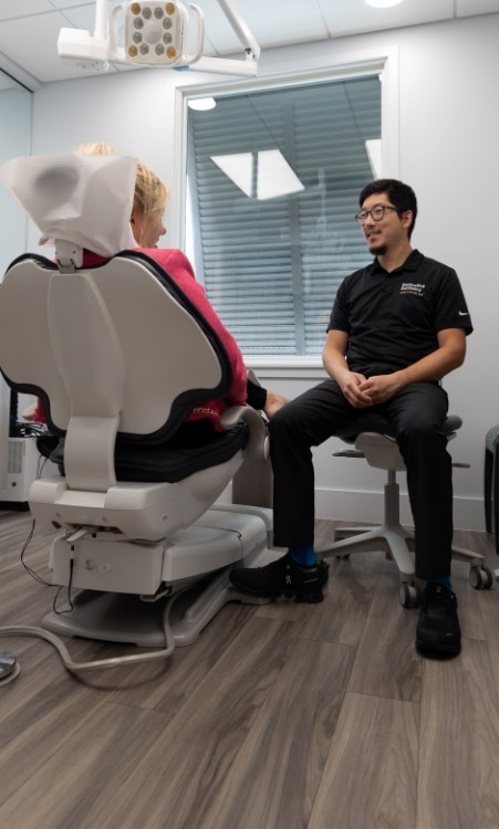 Woman relaxing in dental chair with eyes closed