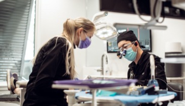 Dentist and team member treating dental patient in Jacksonville