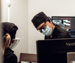Dentist looking at chairside computer monitor