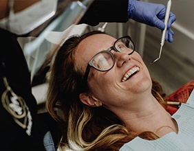 Woman laughing during dental treatment in Jacksonville