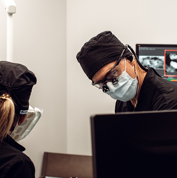 Dentist examining intraoral images on chairside computer