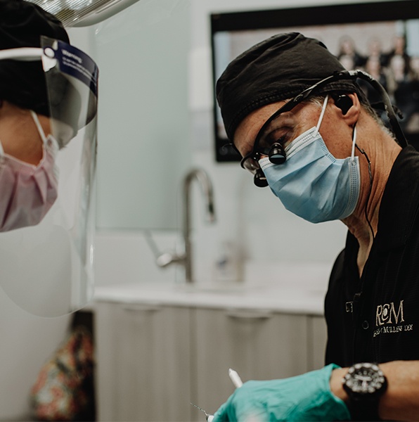 Dentist using cavity detection system during dental exam