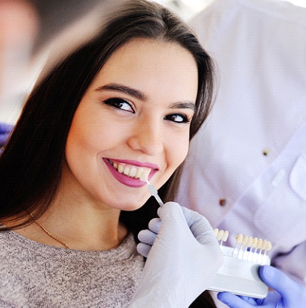 Woman smiles while getting porcelain veneers in Jacksonville