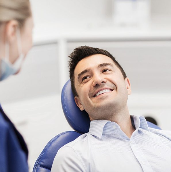 man talking to dentist about veneers in Jacksonville