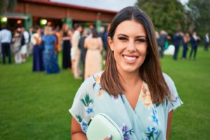 Woman smiling while attending summer wedding